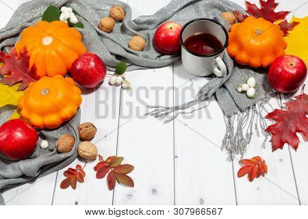Bright Fall Horizontal Background With Orange Pumpkins And Red Apples, Nuts, Cup Of Tea, Green And Y