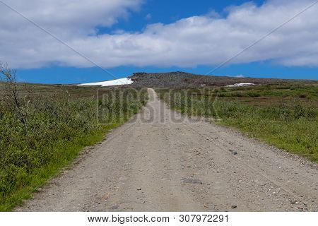 The Road Leading Up Anvil Mountain Through The Tundra In Nome Alaska.
