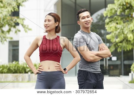 Positive Fitness Trainers In Sports Clothes Standing Outdoots