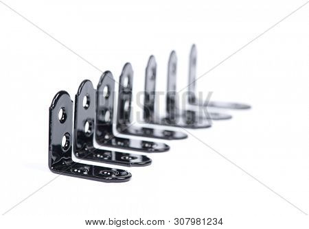 Group of  black metallic angle fixators. Mounting metal angle corners brackets isolated on white background