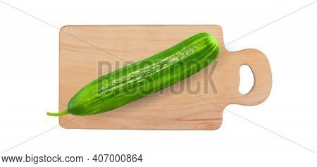 Сucumber Whole On A Cutting Wooden Board Isolated On A White Background With Clipping Path.