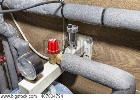 Expansion Vessel Protecting Against Pressure In A Modern Boiler Room Lined With Ceramic Tiles For Na