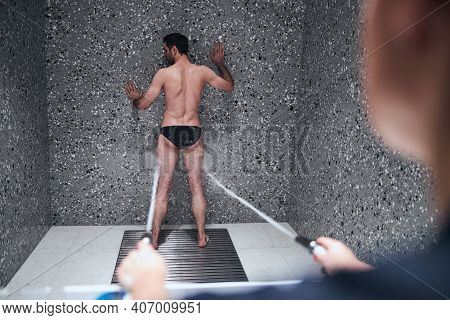 Lean Man Being Treated With Charcot Douche