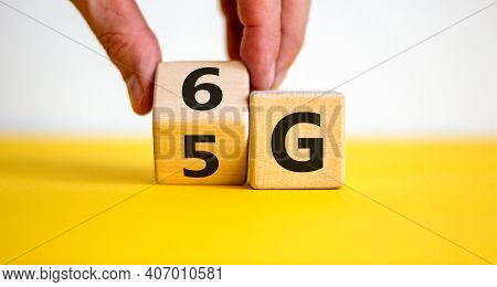 Time To 6g Symbol. Businessman Turns A Wooden Cube And Changes Sign 5g To 6g. Technology, Business, 