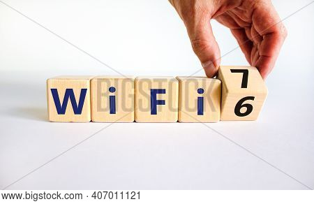 Wifi 6 Or 7 Symbol. Businessman Turns A Wooden Cube And Changes The Words Wifi 6 To Wifi 7. Beautifu
