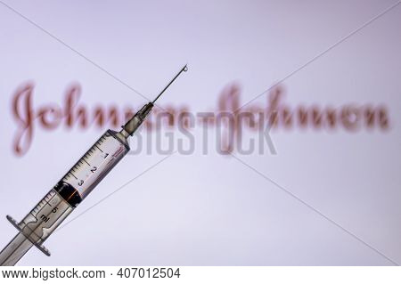 Kathmandu, Nepal - February 7 2021: Syringe Injection Placed Against Johnson And Johnson Logo. Jnj C