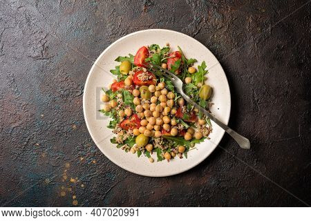 Healthy Vegetarian Salad With Cooked Chickpeas, Chia Seeds, Fresh Arugula, Cherry Tomatoes And Olive