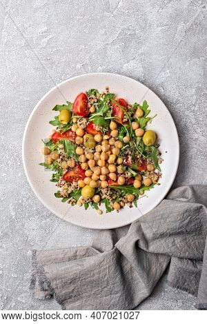 Healthy Vegetarian Salad With Cooked Chickpeas, Chia Seeds, Fresh Arugula, Cherry Tomatoes And Olive