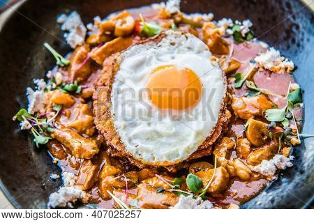 Chicken sote with pancakes and egg. The food in the restaurant. Food styling and restaurant meal serving.