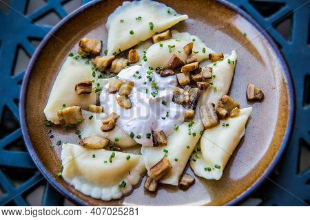 Traditional Slovak Food - Bryndzove Pyrohy With Bacon On Plate. Sheep Cheese Dumplings With Bacon An