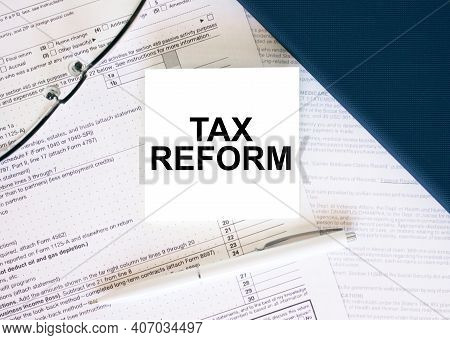 Tax Form With Business Card With Text Tax Reform. Notepad, Eyeglasses And White Pen