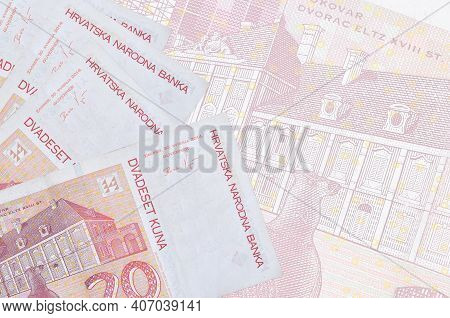 20 Croatian Kuna Bills Lies In Stack On Background Of Big Semi-transparent Banknote. Abstract Busine