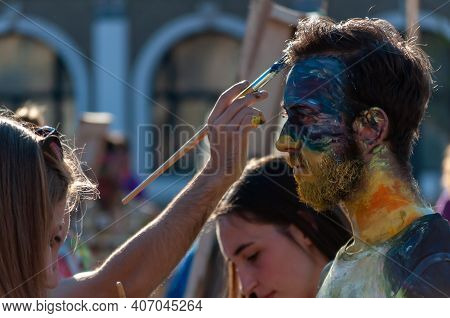 Timisoara, Romania - March 31, 2017: People Painting On A Human Statue At The Checkart Carnaval