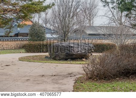 Dolmen Burial Chamber With Large Boulder Used As Capstone On Top Of Smaller Stones In Neolithic Park