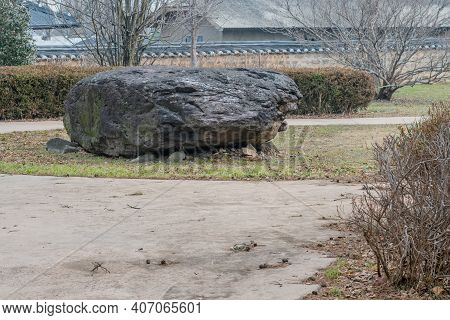 Dolmen Burial Chamber With Large Boulder Used As Capstone On Top Of Smaller Stones In Neolithic Park