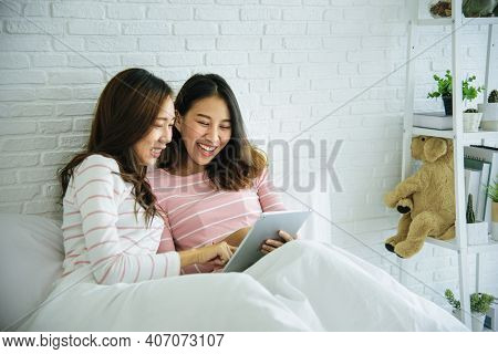 Two Pretty Best Friends Forever Girlfriend Talk, Hug And Laugh Together On Bed At Cozy Home Relation