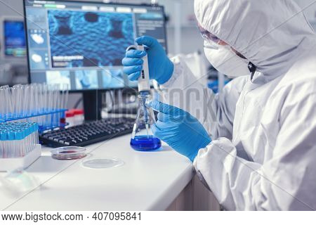 Man In Scientific Lab Working With Micropipette And Petri Dish During Global Pandemic. Chemist In Mo