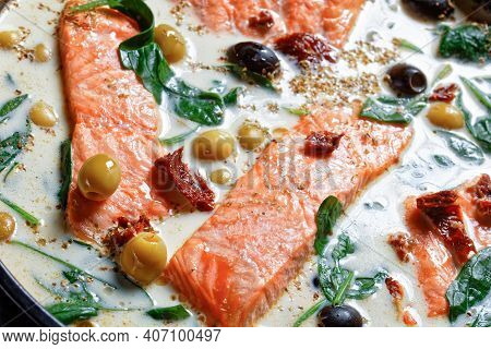 Tuscan Salmon Dish Of Pan-seared Skin-on Salmon Fillet With Cream Sauce, Garlic, Leek, Sun-dried Tom