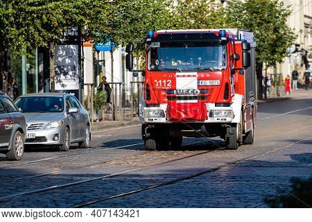 Riga, Latvia - October 7, 2020:a Fire Truck With Warning Lights On Goes To A Call On A Paved Street 
