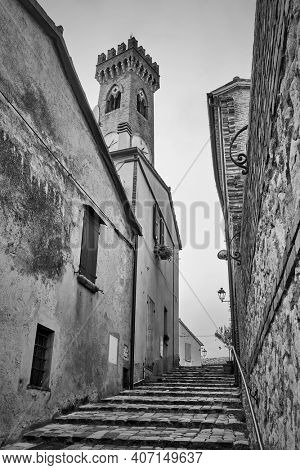 Old uphill street with staits in Santarcangelo di Romagna, Rimini province, Italy. Black and white photography, cityscape