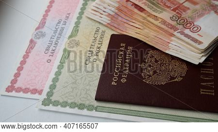 Maikop, Adygea Republic, Russia - February 6, 2021: Money In Rubles In Combination With Birth Certif
