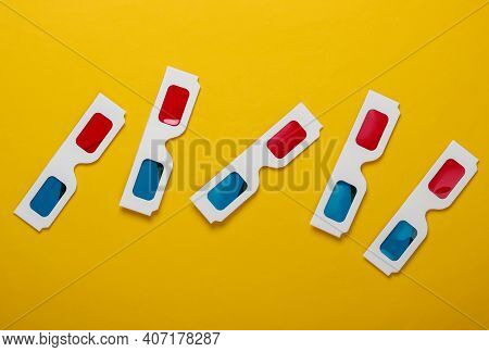 Movie Time. Many Stereoscopic Anaglyph Disposable Paper 3d Glasses On Yellow Background. Top View