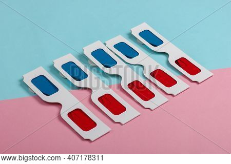 Many Stereoscopic Anaglyph Disposable Paper 3d Glasses On Pink Blue Pastel Background.