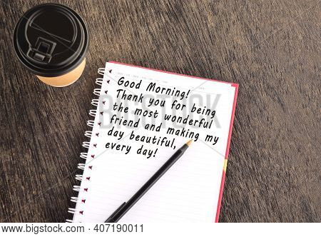 Text On Notepad With Disposable Coffee Cup And Pen On Wooden Table