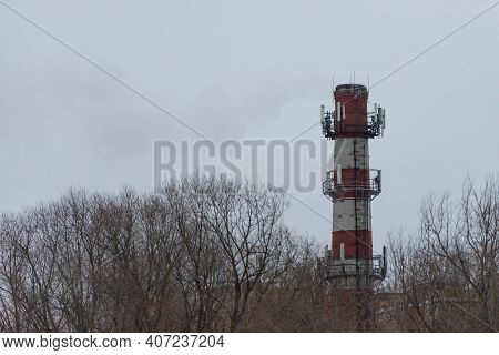 Brick Pipe With Telecommunications Equipment. Cellular Equipment On The Chpp Pipe.