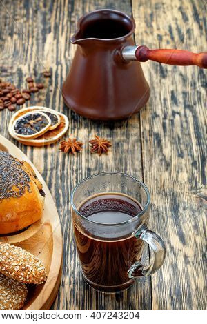 A Freshly Made Espresso Coffee In A Clear Glass Cup Stands Next To A Muffin On An Old Striped Wooden