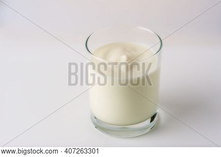 Glass Cup Of Fresh Yogurt On A White Background