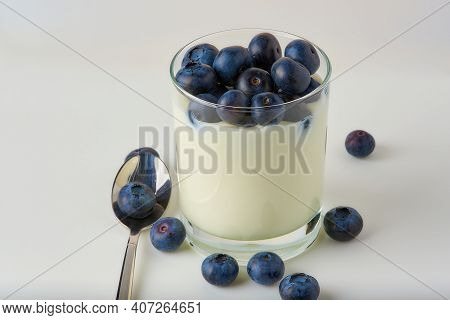 Blueberries With Yogurt On A White Background