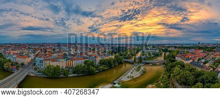 Aerial Panoramic View In Muenchen With The Central Flowing Isar River At The Aerly Morning At Sunris