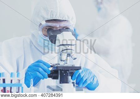 Male Scientist Look Into Microscope Research In Science Laboratory. Asian Scientist Looking Equipmen
