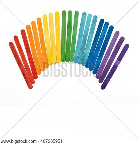 Rainbow Color Wooden Ice Cream Sticks On White.