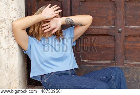 Young Woman Hide Her Face With Hands, Protecting Her Against Violence. Victim