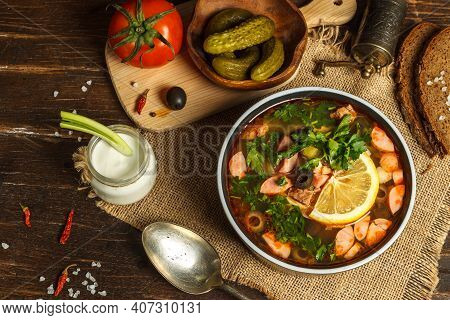 Solyanka, A Thick Soup With Different Types Of Meat And Sausages, With The Addition Of Gherkins, Oli