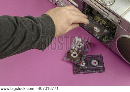 Hand Inserts The Audio Cassette Into The Boom Box. Boom Box Stereo Radio Cassette Recorder And Rando