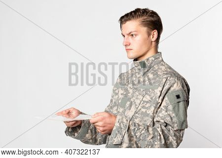 Military man using transparent tablet training military technology