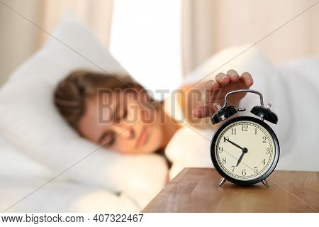 Sleepy Young Woman Stretching Hand To Ringing Alarm Willing Turn It Off. Early Wake Up, Not Getting 