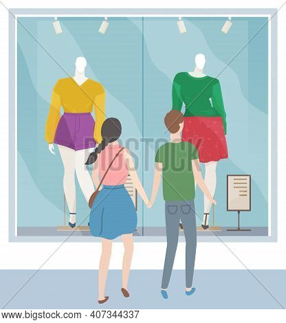 Man And Woman Walking On The Street Of City. Couple Enjoying Time Together And Looking At Store Wind
