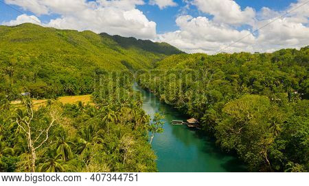 Aerial Drone Of Tropical Loboc River In The Rainforest. Mountain River Flows Through Green Forest. B