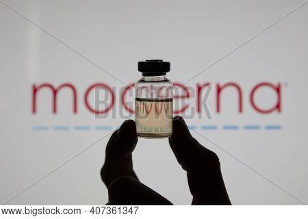 Oxford, Uk - February 2020: A Covid Vaccine Vial Against The Moderna Logo