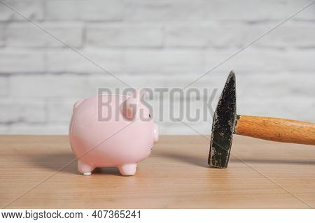 Piggy Bank And Hammer - Concept For Breaking Or Smashing Piggybank Or Coin Bank To Plunder Savings