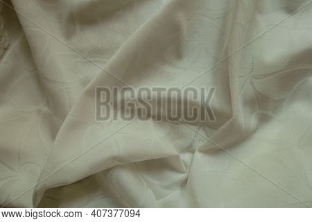 Glossy Cream Colored Polyamide Fabric With Floral Pattern In Soft Folds
