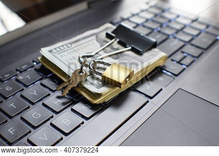 Cyber Security Concept With Small Gold Key Lock On Money Protecting It From Online Hackers And Scamm