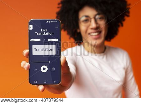 Cheerful Black Guy Showing Smartphone With Opened Voice Translation App On Screen, Using Online Tran