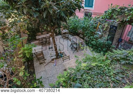 Corniglia, Italy - October, 2020: Cityscape. View Of Open-air Street Cafe In Corniglia Village In Ci