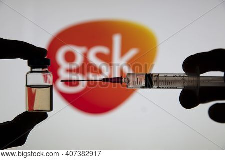 Oxford, Uk - February 2020: Glaxosmithkline Logo With A Covid Vaccine Syringe