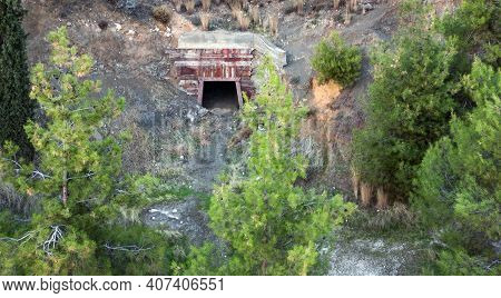 Open Entrance Into Old Abandoned Mine Hidden Behind The Trees, Aerial View